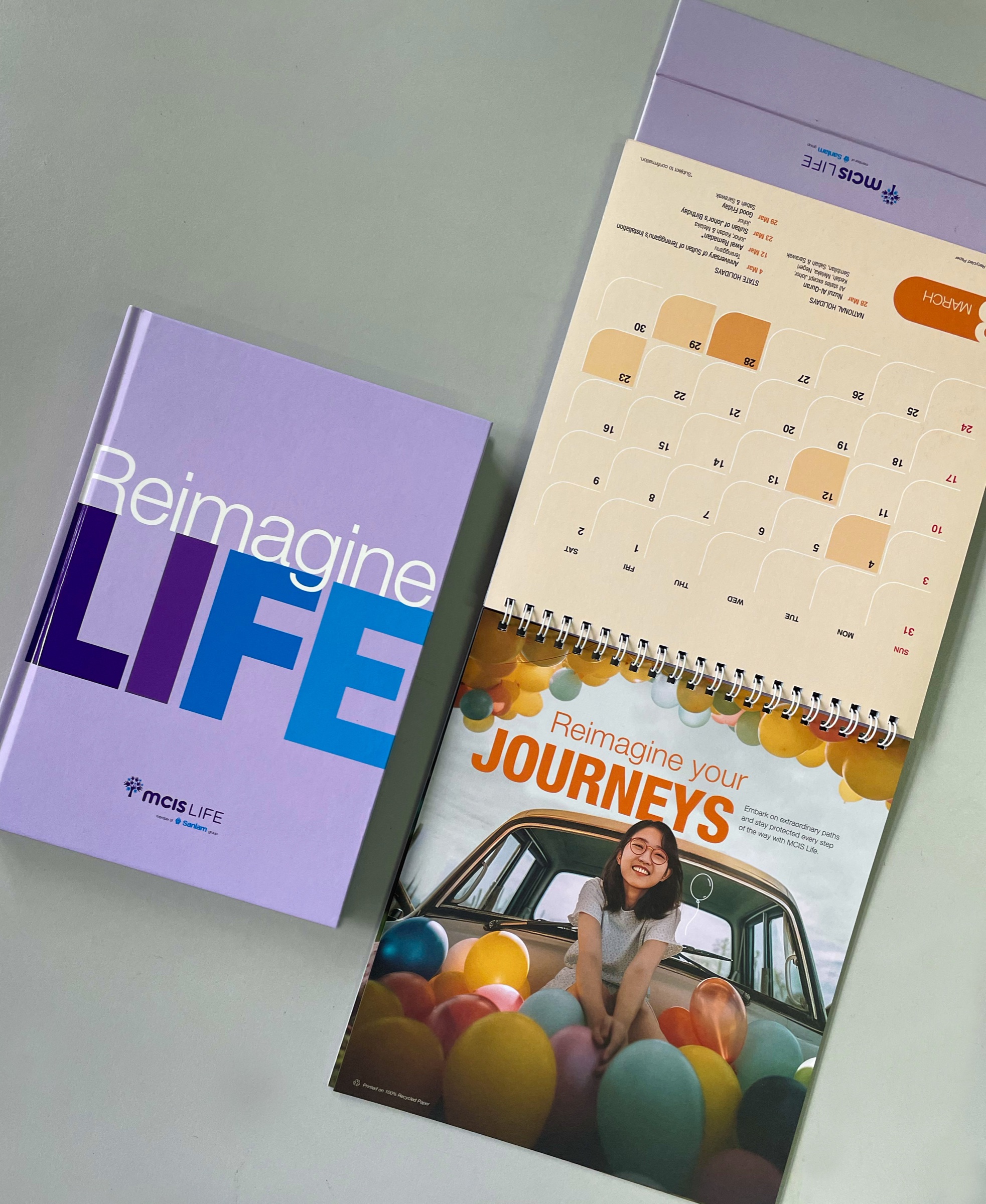 A colourful MCIS Life calendar and companion notebook
